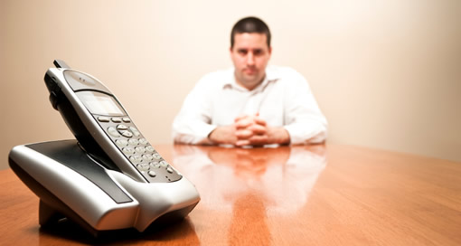Man in a business shirt waits for a call