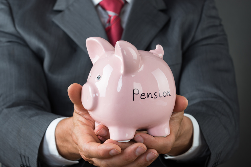 Businessman Holding Piggy Bank With Pension
