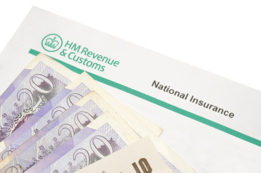 UK cash on top of an HMRC national insurance document
